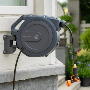 Giraffe Tools Retractable Garden Hose Reel-1/2in-100ft Features a wall-mounted hose reel with nozzle for neat garden watering.