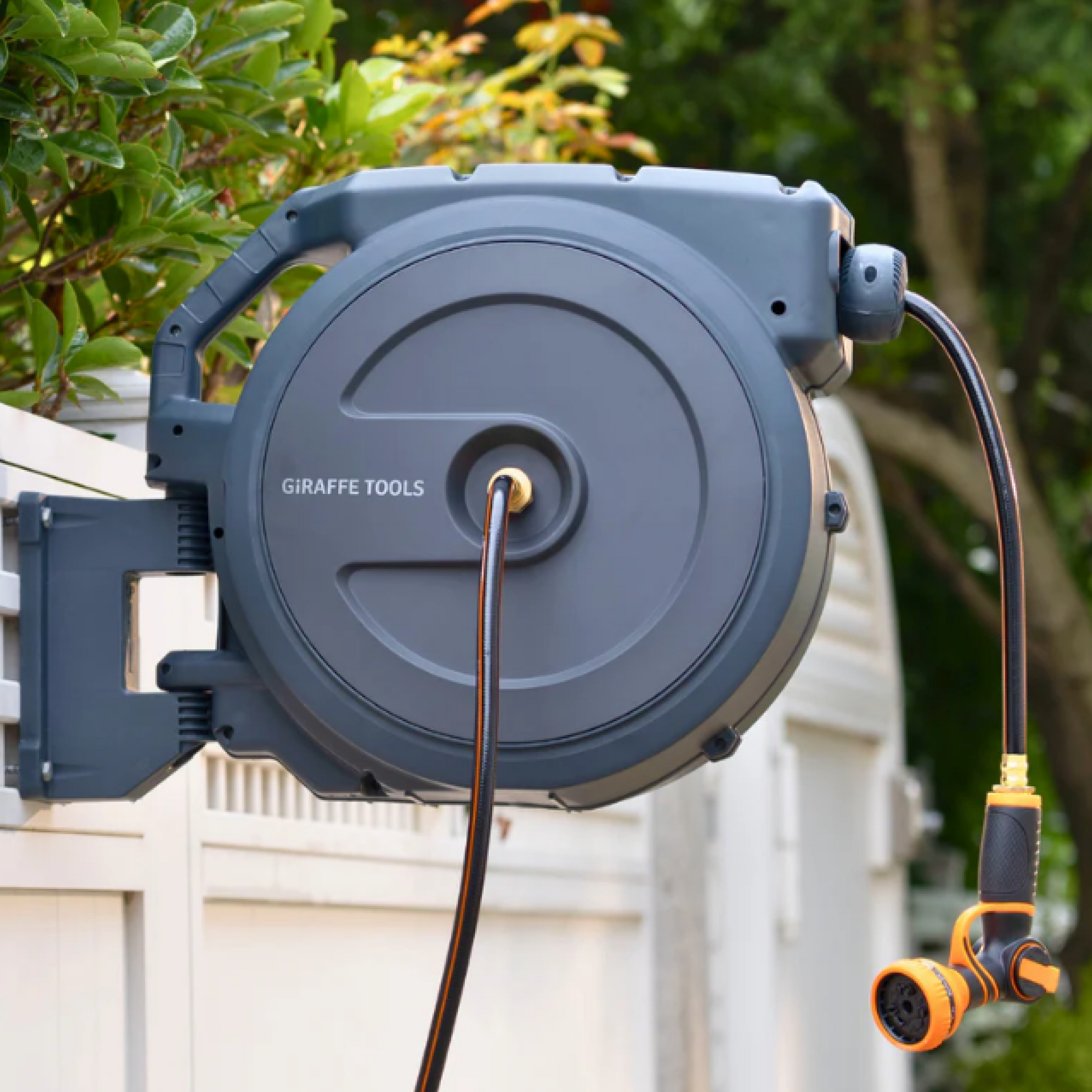 Giraffe Tools Retractable Garden Hose Reel-1/2in-130ft Features a wall-mounted hose reel with nozzle for neat garden watering.