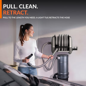 Woman pulling out the retractable vacuum hose for cleaning.