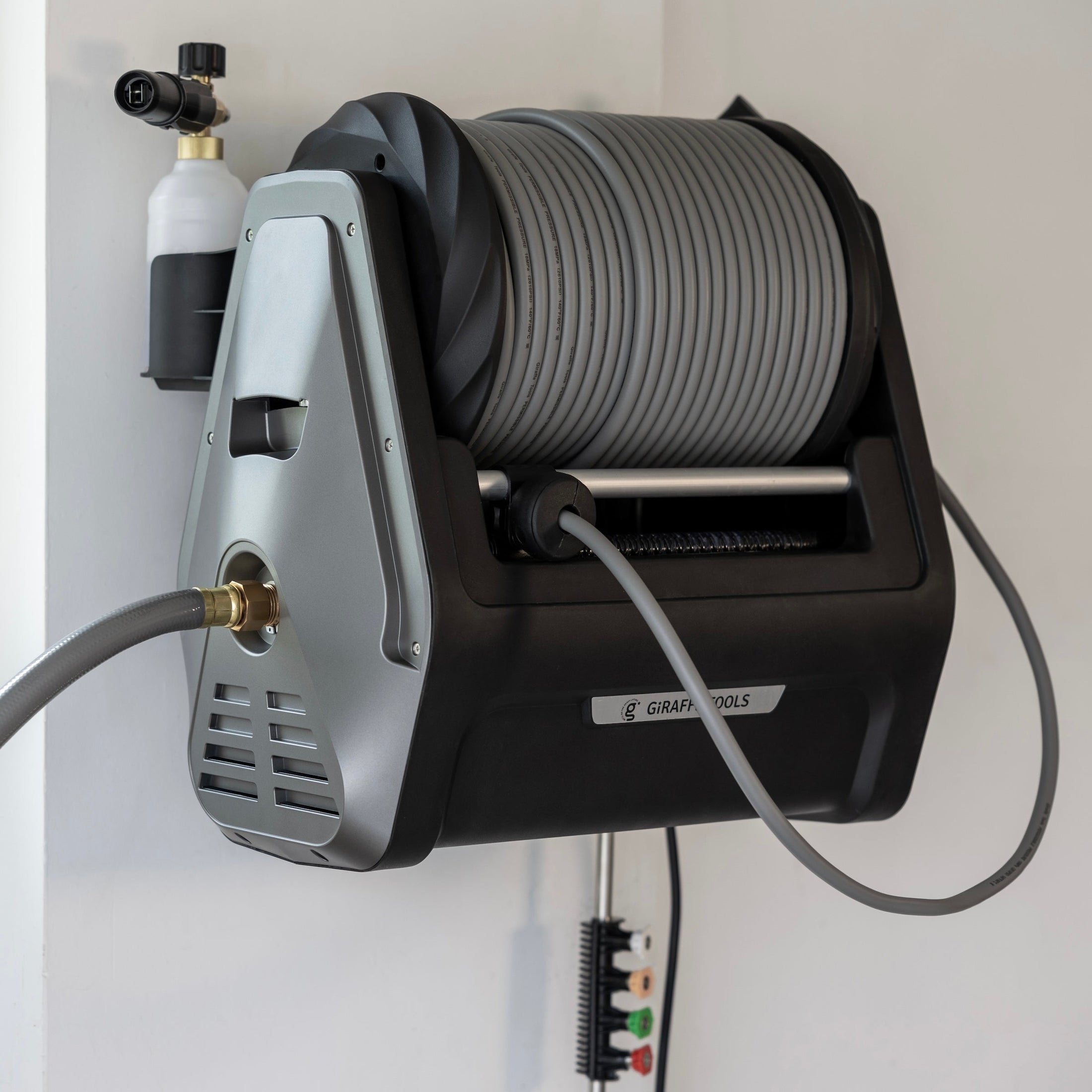 Giraffe Tools Grandfalls Retractable Pressure Washer Plus Features showing a neatly wound hose reel and side-mounted foam cannon storage for easy access